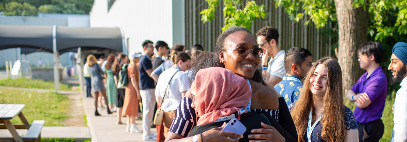 Alumni hugging.