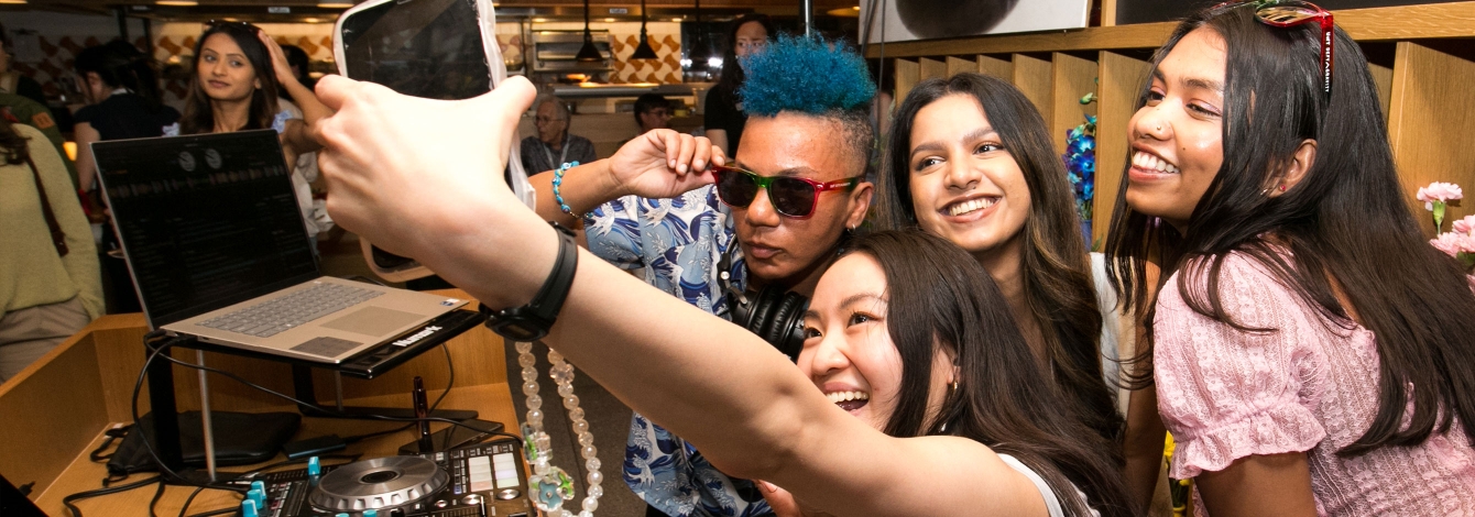 Young U of T alumni together taking a selfie.