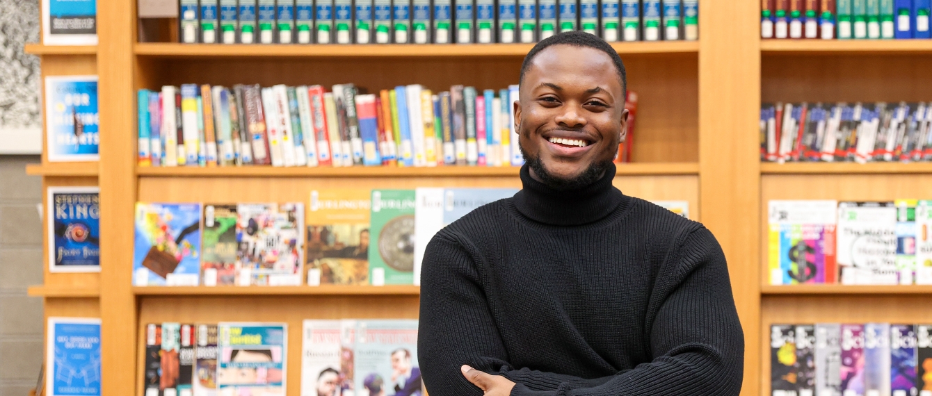 Picture of Michael Gayle-big smiling in front of books.