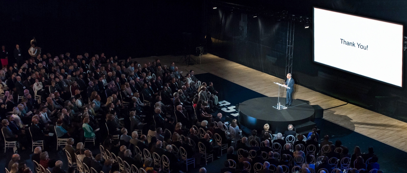 President Meric Gertler on stage in front of Thank You background presentation