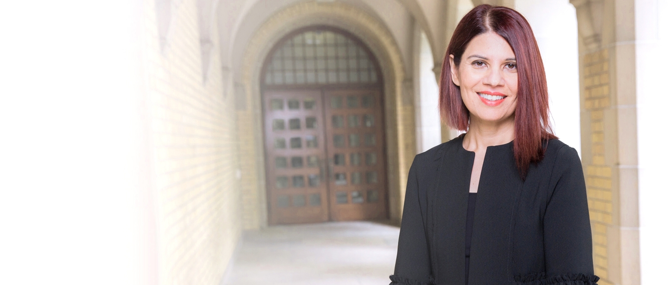 Ismat Aziz on U of T campus, smiling