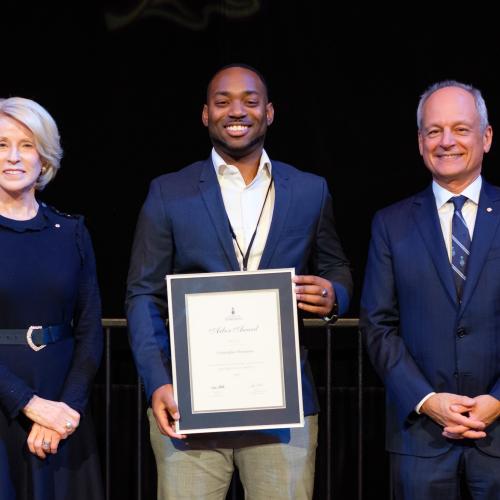 Award winner holding their certificate