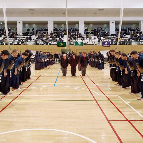 U of T alumni bow respectfully to each other before a kendo event.