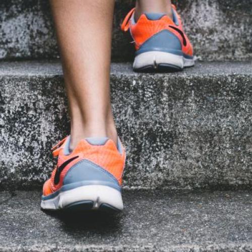 Closeup of jogger's feet in running shoes going up steps