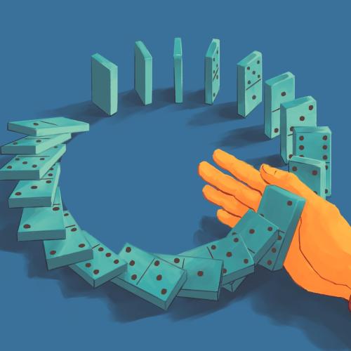 Circle of dominoes falling with a hand interrupting. 