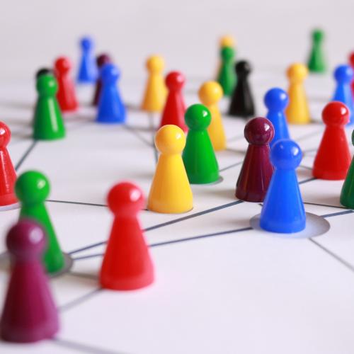 Multi-coloured game pieces connected by black lines