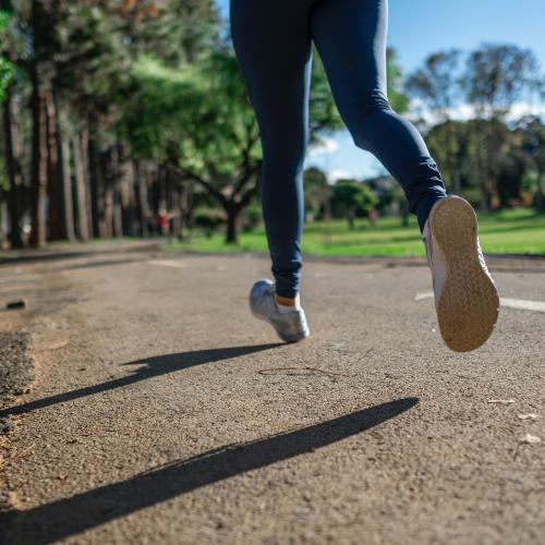 Shot of person running on a park road