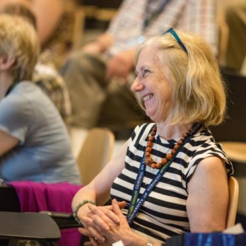 Woman smiling listening to lecture