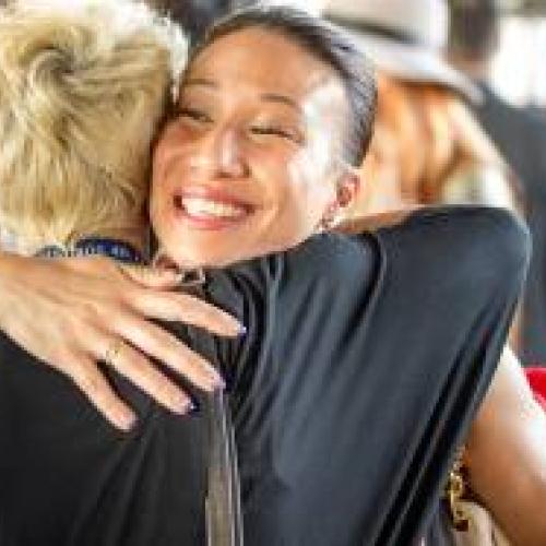 Two female alumni hugging each other