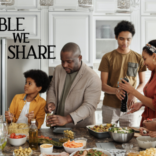 Picture of a family in the kitchen making food
