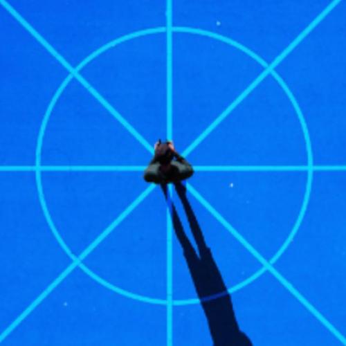 Person standing on target with long shadow