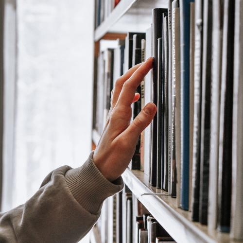 Person choosing a book. 