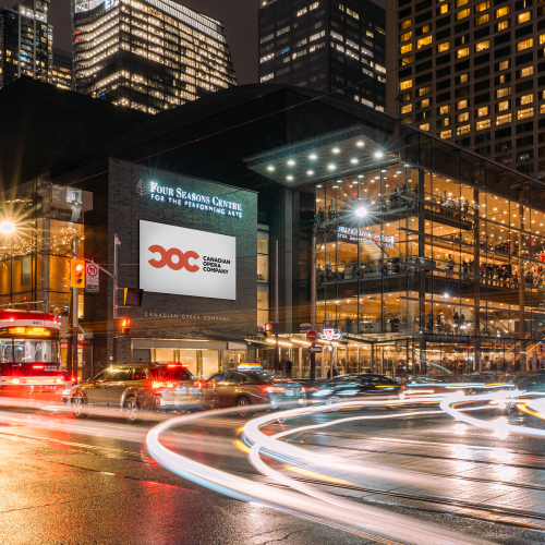Four Seasons Centre building with street traffic lights glowing
