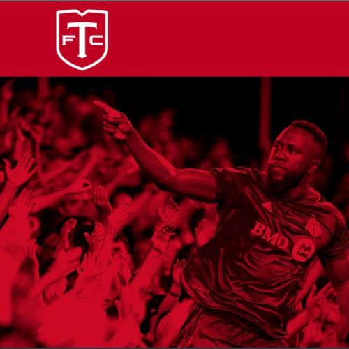 Red-tone image of TFC player pointing at the crowd.