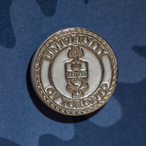 Photo of pin against blue background.