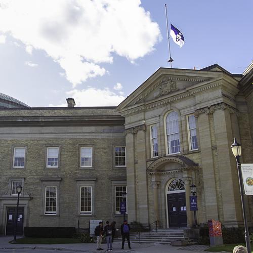 The University of Toronto flag flies at half mast on the roof of Simcoe Hall on Front Campus.