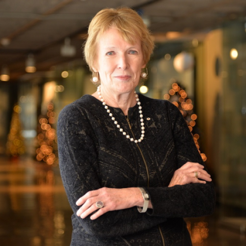 Margaret Macmillan smiling with her arms crossed