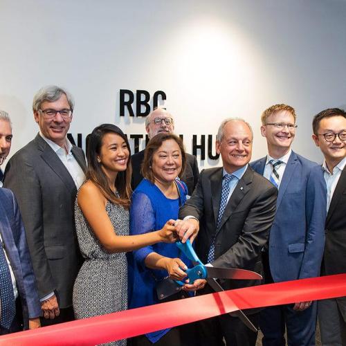 Entrepreneur Tricia Jose, Impact Centre Director Cynthia Goh and U of T President Meric Gertler cut the ribbon on U of T's new ONRamp facility as RBC CEO David McKay (fourth from left) and other U of T and RBC officials look on (photo by Chris Sorensen)