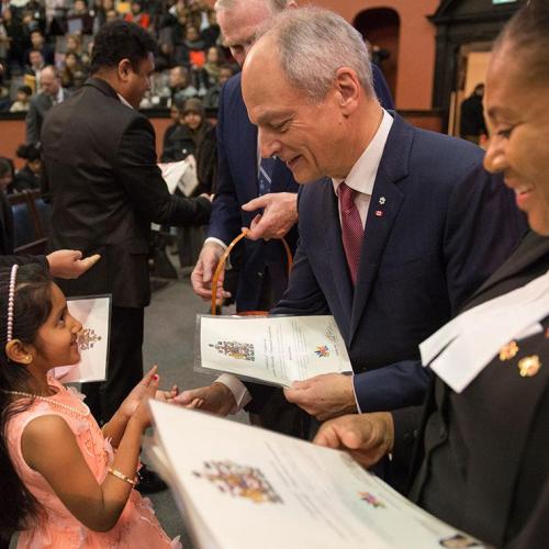 U of T President Meric Gertler greets a young, new Canadian at a citizenship ceremony in Convocation Hall on Saturday (all photos by Laura Pedersen) 