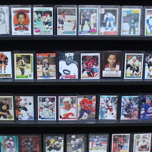 A display of laminated hockey cards on a bookcase.