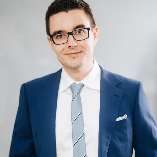 Portrait of Alik wearing a navy blue suit