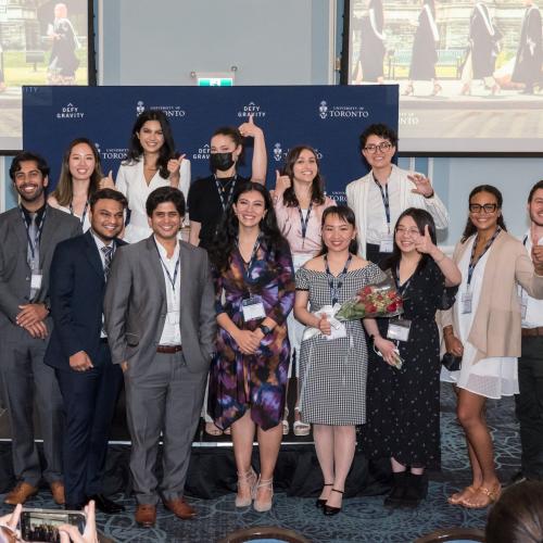 The graduating Pearson Scholars smile and give the thumbs up as they pose for a photo.