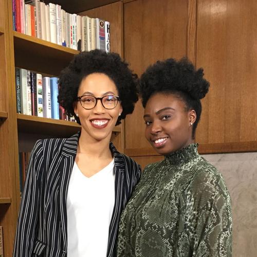 Anna-Kay Russell and Eunice Kays smile together in a library.