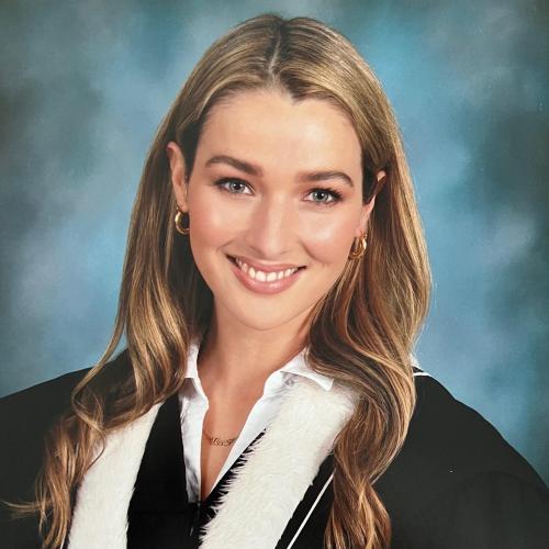 Annie Clark smiles in a formal graduation portrait.