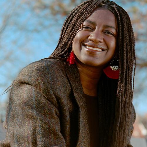 Portrait image of Tea Mutonji smiling.