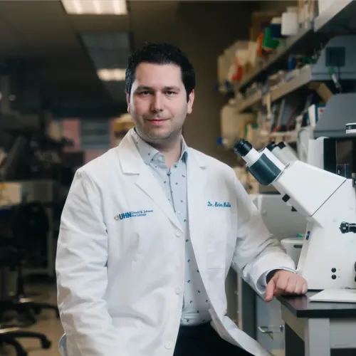 Brian in a lab wearing a white coat