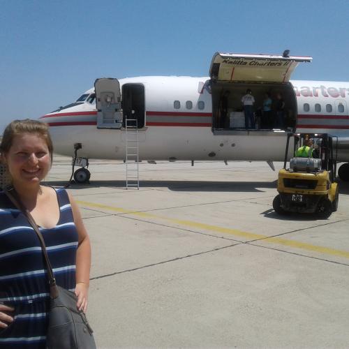 Camilla Urbaniak standing in front of the NASA plane that holds her research samples.
