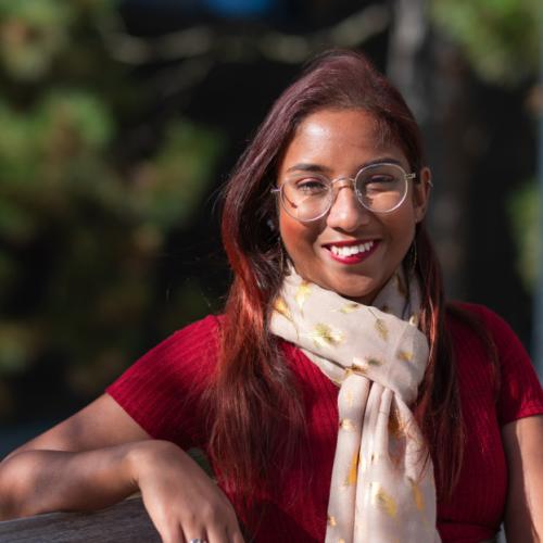 Portrait of Rashmi de Silva Wijeyeratne sitting on a bench