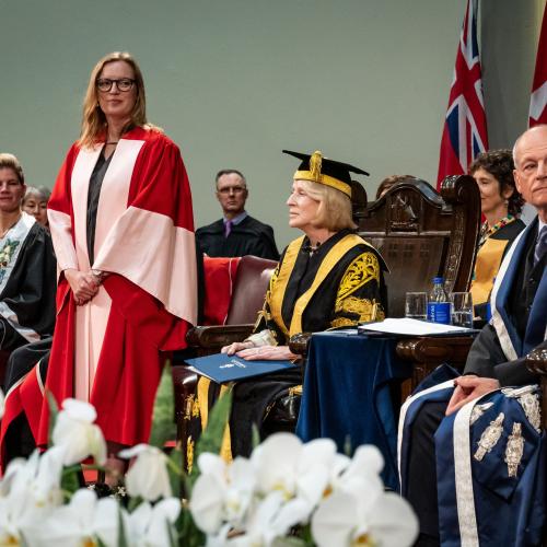 Sarah Polley on stage in a gown receiving her degree