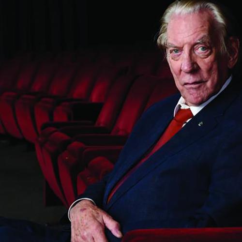 Portrait of Donald Sutherland sitting in a theatre