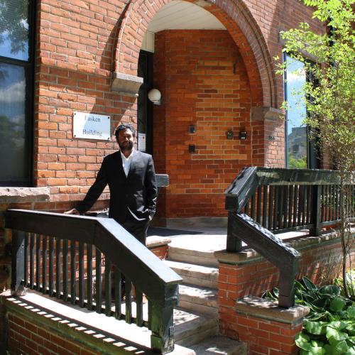 Prasanna Balasundaram at the U of T community legal clinic on Spadina Avenue, an old brick building in a garden.