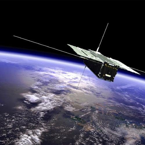 A box-shaped satellite with solar panels spread out like wings floats high above the Earth. A logo on its side says Kepler.
