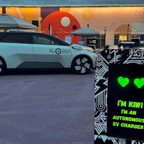 A car parked next to a Kiwi autonomous EV charger