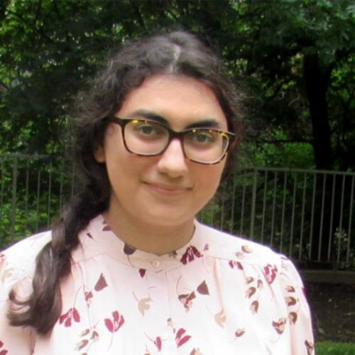 Fatima Azahraa Al Saadie smiles while standing in a park outdoors.