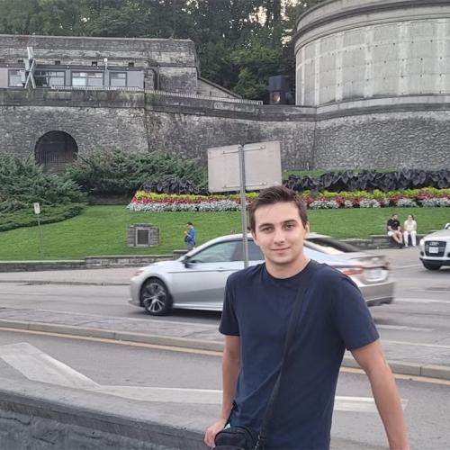 Rahul Kalvapalle posing outdoors in front of a road