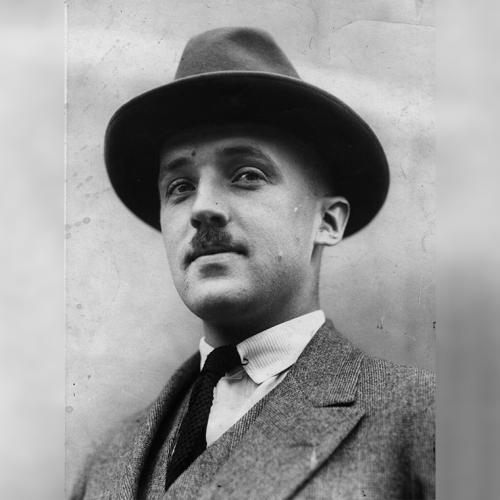 Portrait of Charles Best looking serious in a hat outdoors.