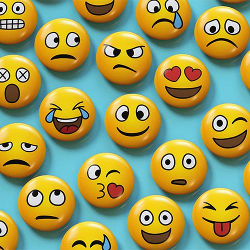 An array of emojis show faces smiling, frowning, winking, sweating, angry, with hearts for eyes, etc.