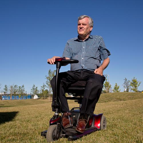 David Onley outside on a motorized wheelchair