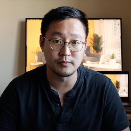 Gimmy Chu looks serious while talking on a video call in a home office.
