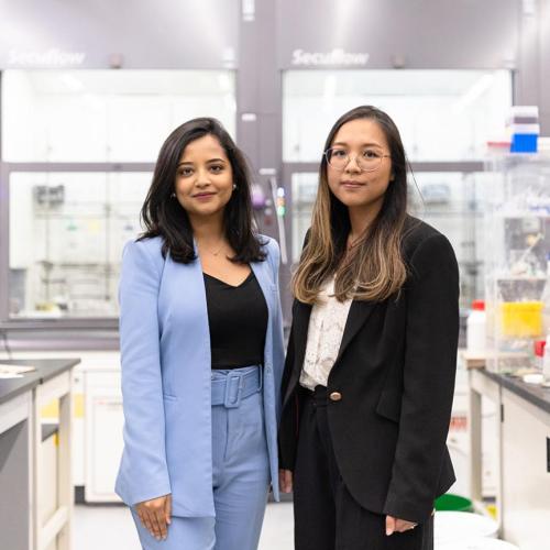 Two women standing in a lab