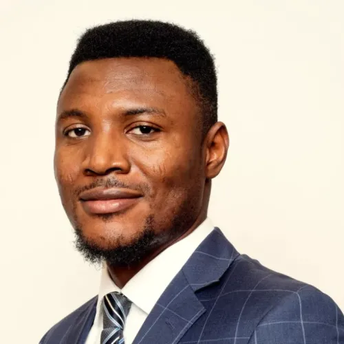 Headshot of entrepreneur Ifeanyi Eze-Onuorah wearing a suit and tie.