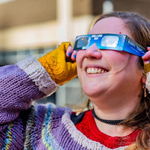 Ilana wearing solar eclipse glasses