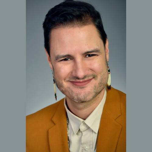 Portrait of John Hampton smiling.
