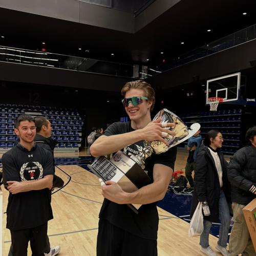 Matthew Kieffer holding a large sports trophy
