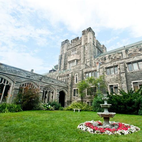 The Knox College quad is a roomy space of lush grass and a sundial, enclosed within an old stone building.