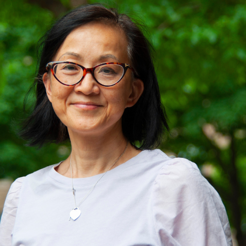 Laura Tam smiling in a garden.